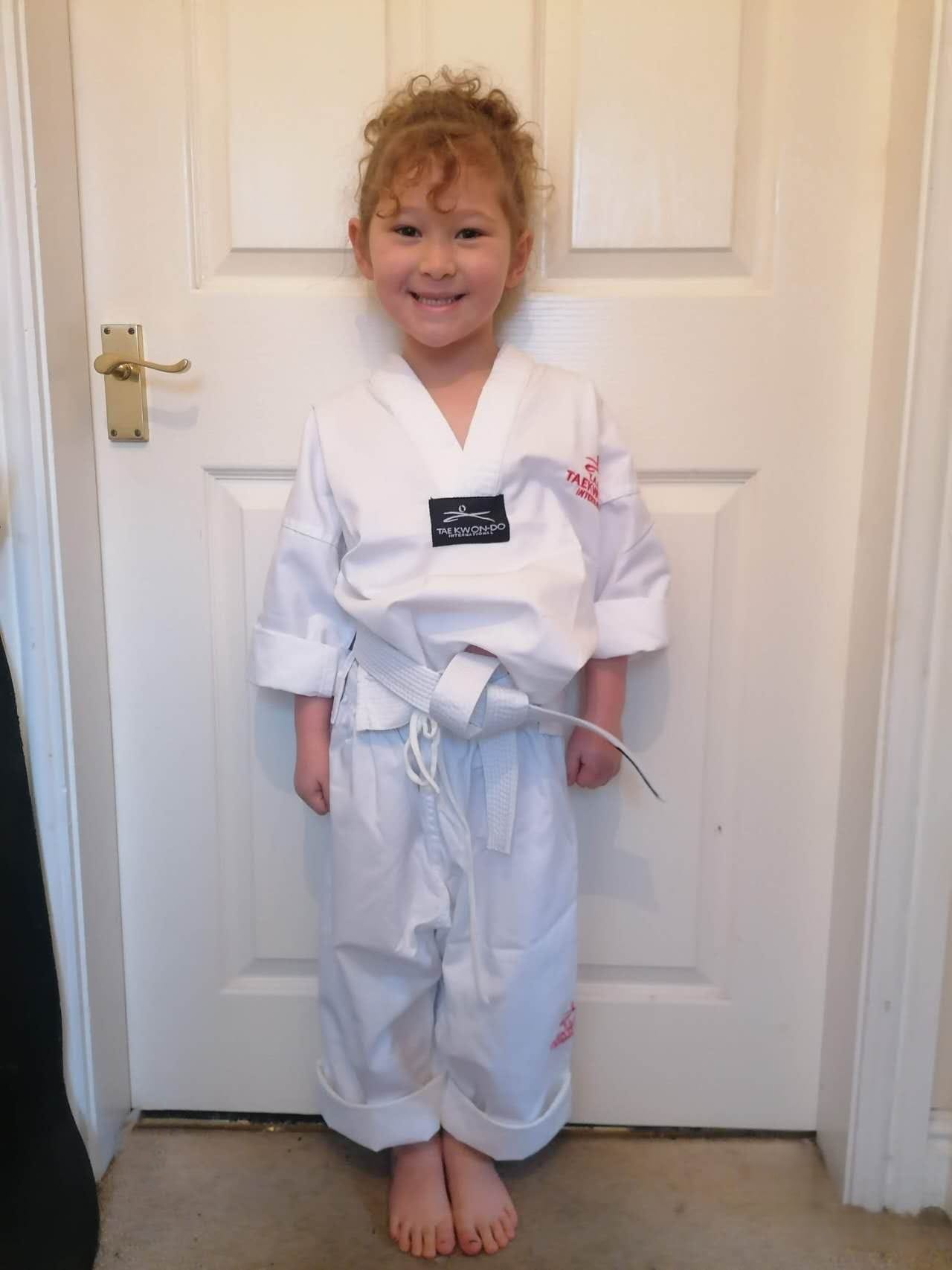 A young Aurora at the beginning of her Taekwondo journey as a White Belt