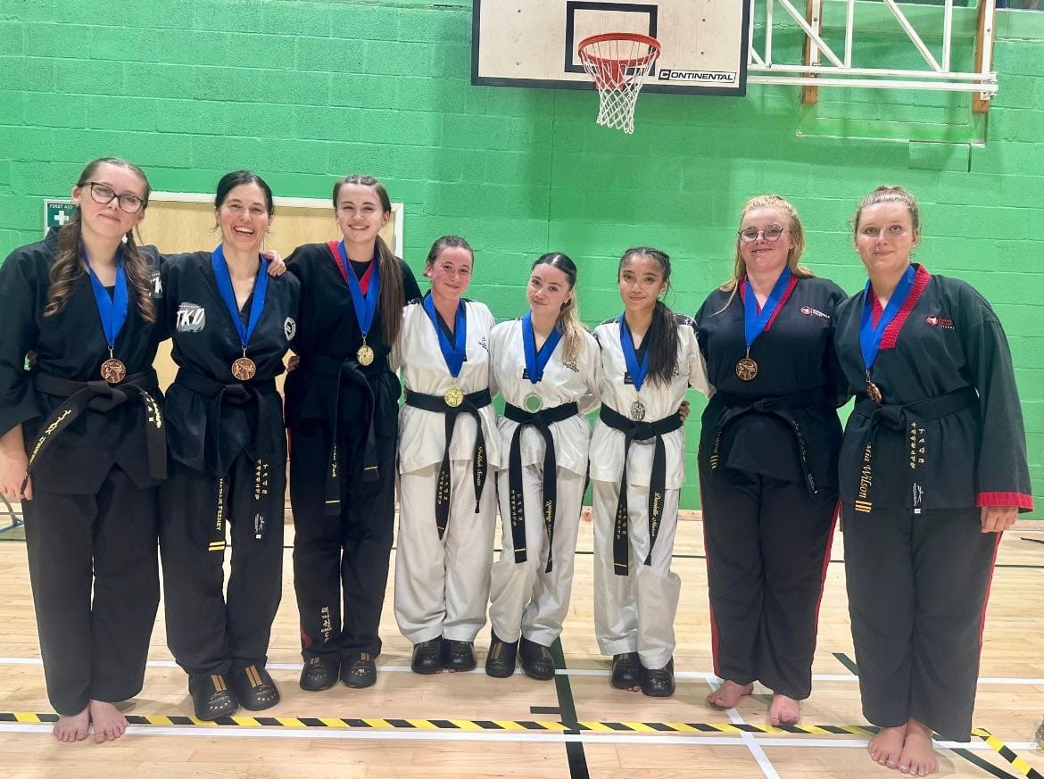 Delilah Smith — group photo with fellow black belt competitors and medals