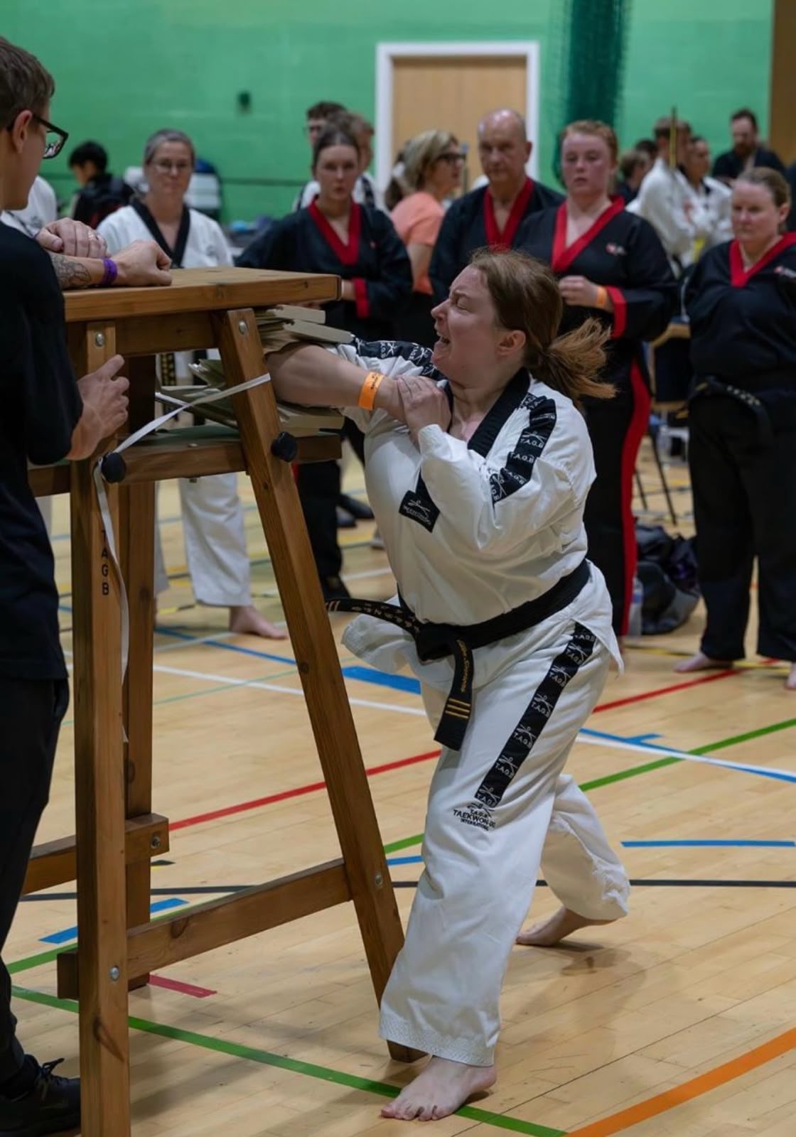 Ellen completing a board-breaking technique at her Black Belt grading