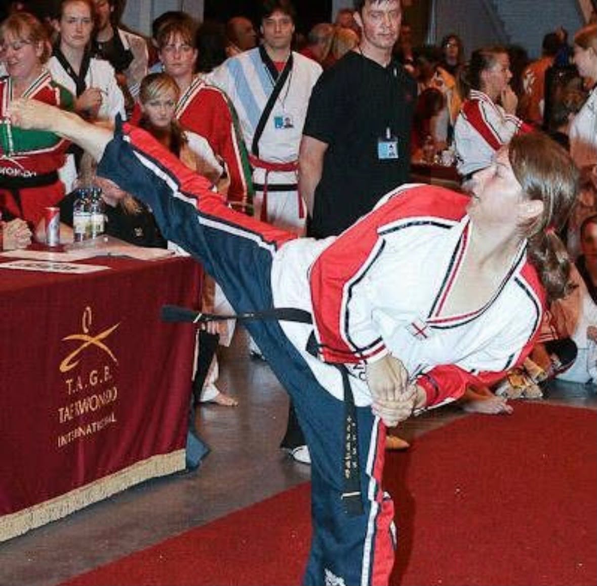 Ellen demonstrating a high kick at a Taekwondo event