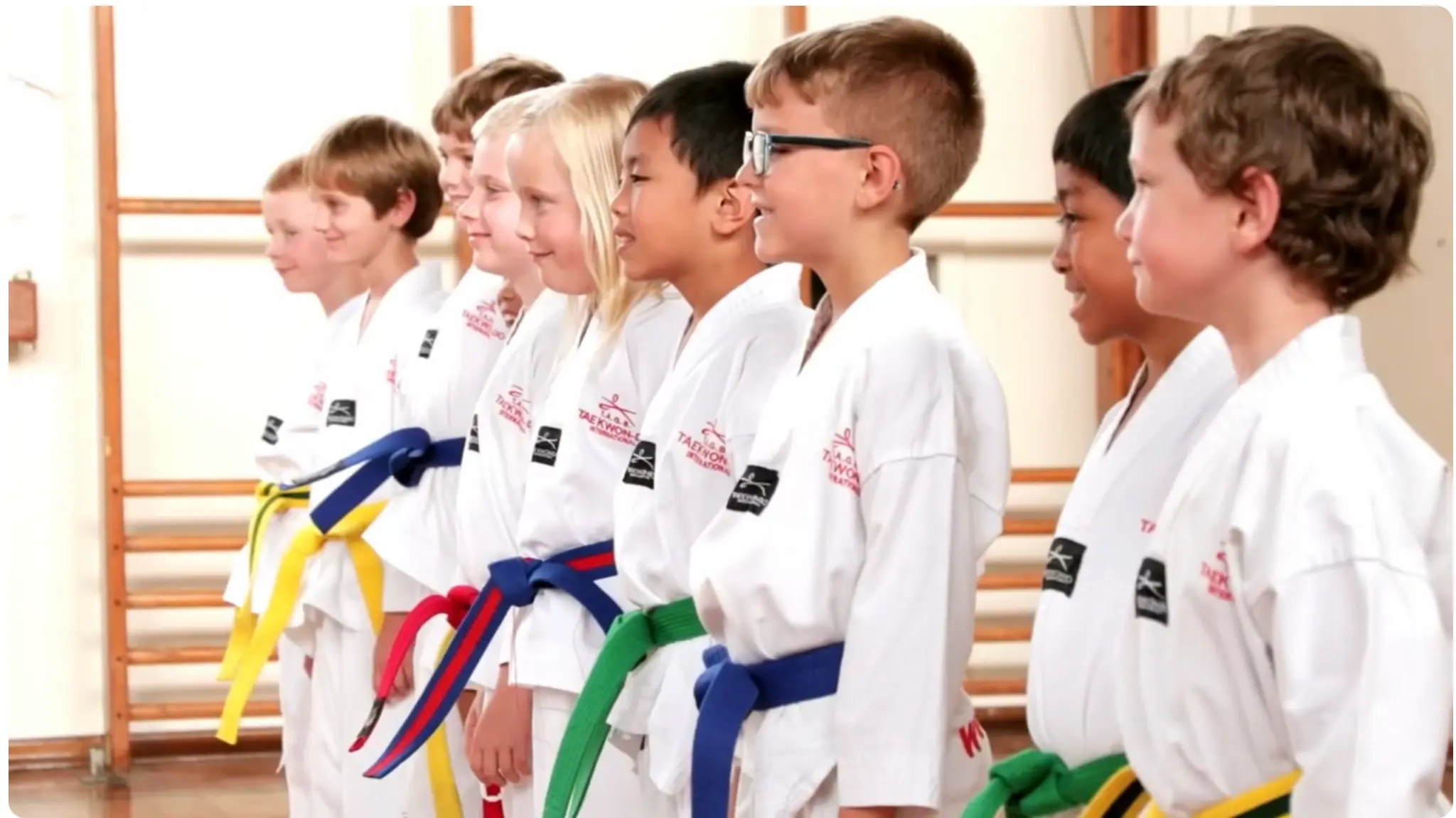 Family Taekwondo class — students lined up in white doboks