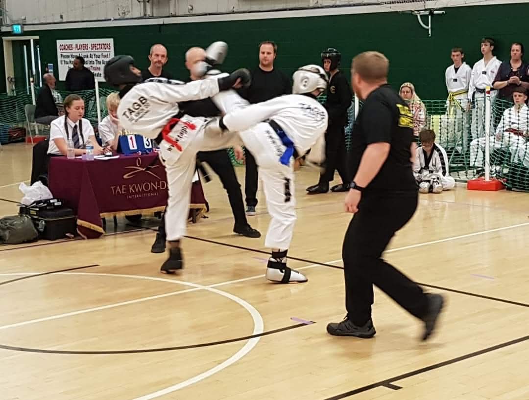Jake sparring in white TAGB dobok at competition