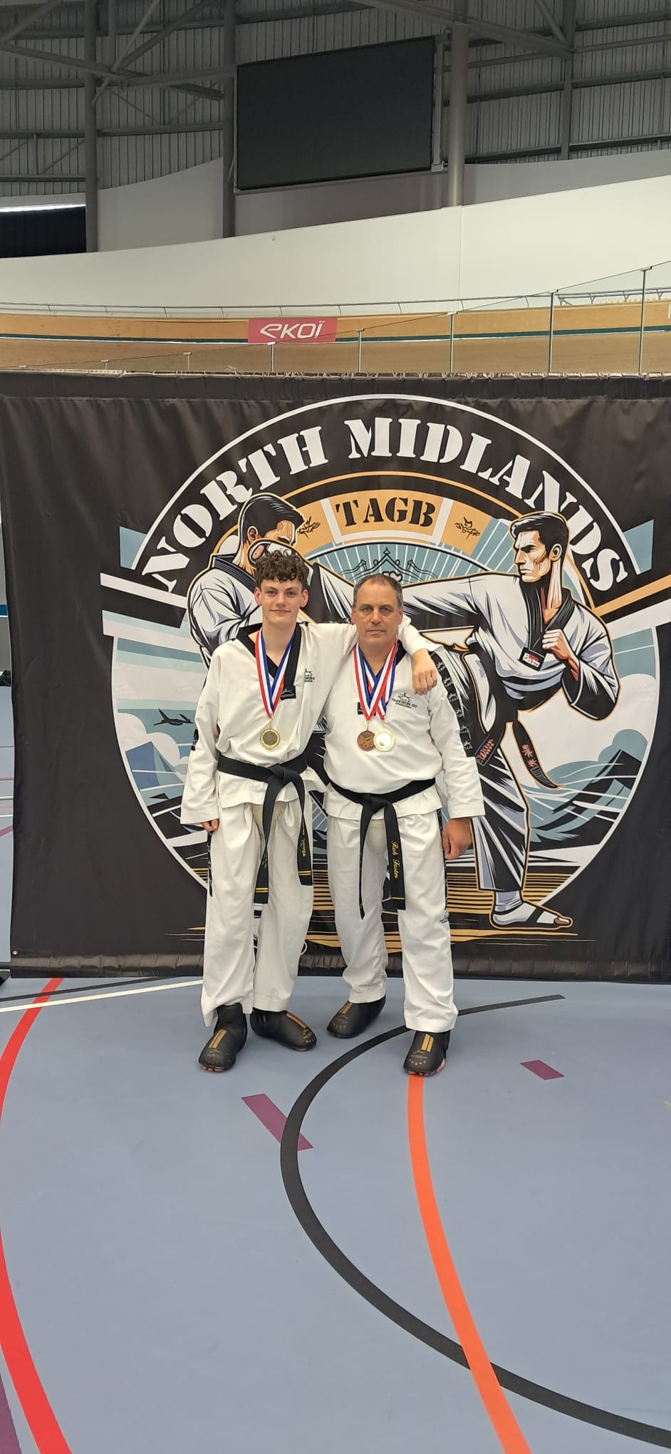 Lucas Foster with Mr Cook at the TAGB North Midlands Championship, both with medals